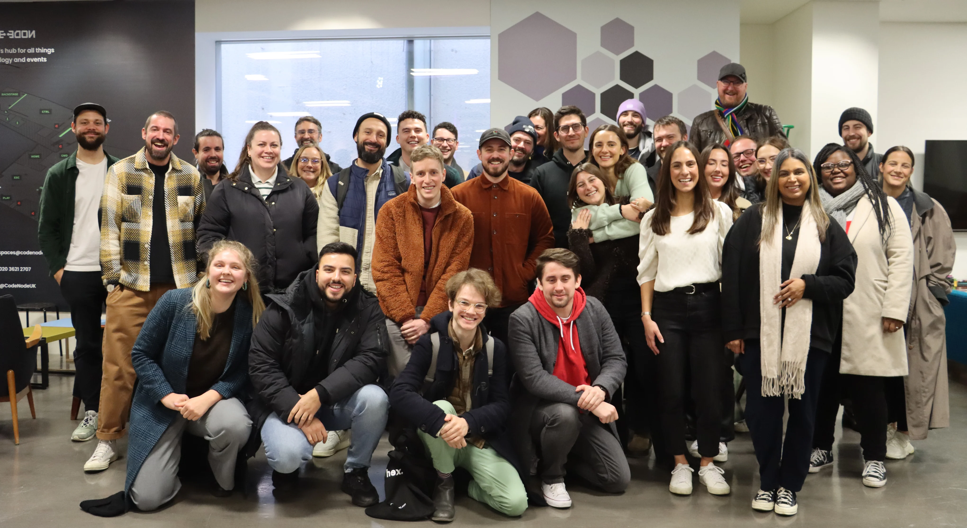 Photo of the team at Hex Digital. There are 31 people in the photo. They look happy and smiling